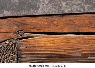 Macro Shot Of An Ancient Weathered Dark Brown Cracked Wood Beam Surface With Nice Rough Grain Texture.