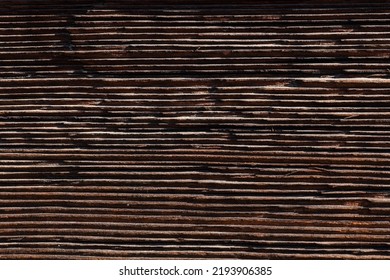 Macro Shot Of An Ancient Weathered Dark Brown Cracked Wood Beam Surface With Nice Rough Grain Texture.