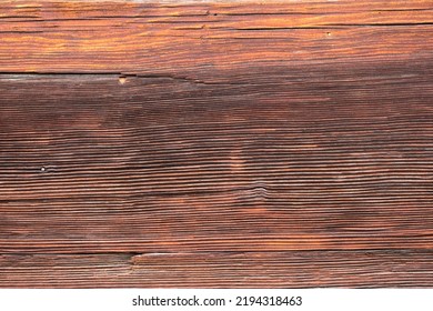 Macro Shot Of An Ancient Weathered Dark Brown Cracked Wood Beam Surface With Nice Rough Grain Texture.