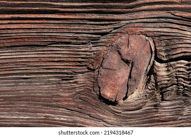 Macro Shot Of An Ancient Weathered Dark Brown Cracked Wood Beam Surface With Nice Rough Grain Texture.