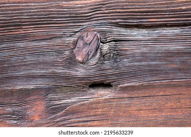 Macro Shot Of An Ancient Weathered Dark Brown Cracked Wood Beam Surface With Nice Rough Grain Texture.