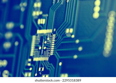 Macro shot of the back side of a circuit board. Close up of the blue circuit board. Circuit board background