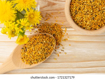 Macro Shot Of Bee Pollen Or Perga In Wooden Spoon On Blurred Rustic Background. Raw Brown, Yellow, Orange And Blue Flower Pollen Grains Or Bee Bread. Healthy Food Supplement With Selective Focus