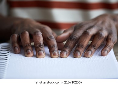 Macro shot of blind African American man reading book in braille, accessible information concept, copy space - Powered by Shutterstock