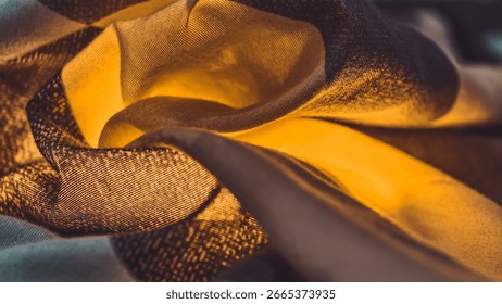 A macro shot capturing the mesmerizing texture of fabric with its intricate weave and golden hues. The play of light and shadow on the folds accentuates the material's soft and smooth texture