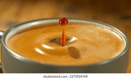 Macro Shot of Coffee Drop Falling into Fresh Espresso Cup