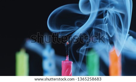 Macro Shot Of Colorful Birthday Cake Candles Smoking After Being Blown Out. 