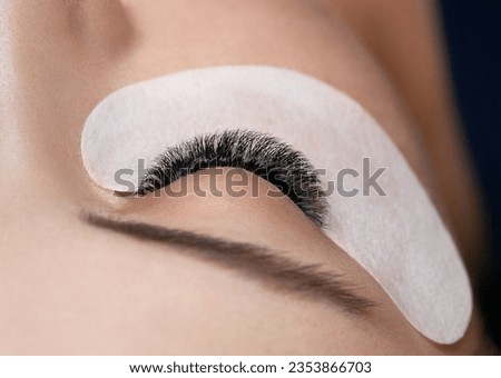 Macro shot of correct application of 2d, 3d, 4d, 5d volume cluster fans artificial lashes. Eyelash Extension Direction Guide. Tips and tricks for application beauty salon procedure of lash extension