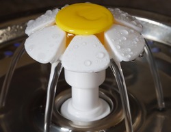 A Macro Shot Of A Daisy Cat Water Fountain In Operation With Water Flowing 
