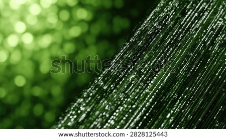 Macro shot of a delicate spiderweb covered in glistening water droplets, set against a soft, blurred background of vibrant green foliage.