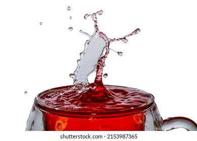 Macro shot of a drop collision in a glass of red water.