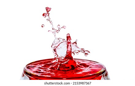 Macro shot of a drop collision in a glass of red water.