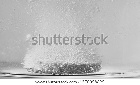 Macro Shot Of Effervescent Pill Dissolving In A Glass Of Water