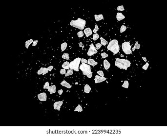 Macro shot of falling and flying salt crystals isolated on black