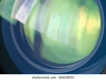 Macro shot of front element of a lens with beautiful color lights reflections