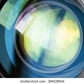 Macro shot of front element of a lens with beautiful color lights reflections
