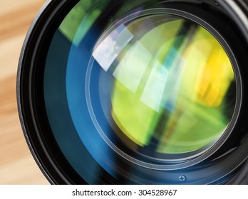Macro shot of front element of a lens with beautiful color lights reflections