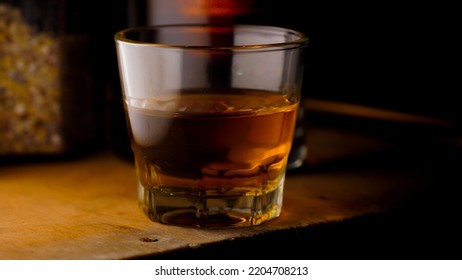 Macro Shot Of A Glass Of Blended Whiskey On A Wooden Table On A Dark Background