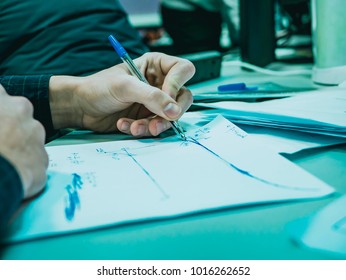 macro shot of hand of businessman writing on paper with pen in office - Shutterstock ID 1016262652