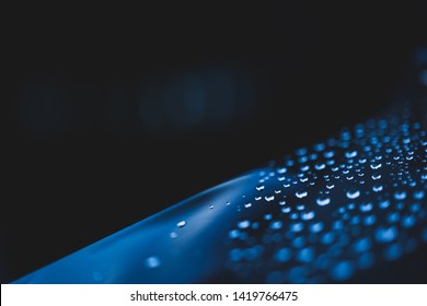 Macro shot of a hydrophobic material. Water drops on a thin film against dark background. Hydrophobic coating. Water-repellent or Water-resistant Concept. High Resolution Scientific Photography. - Shutterstock ID 1419766475