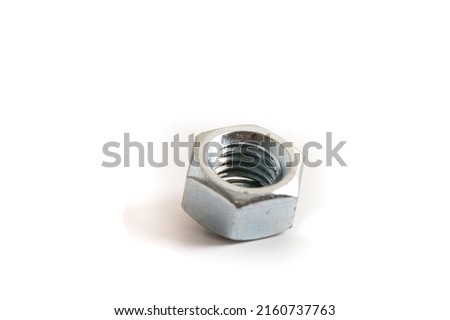 Macro shot metal nut isolated on white background. Chromed screw nut isolated. Steel nut isolated. Nuts and bolts. Tools for work.