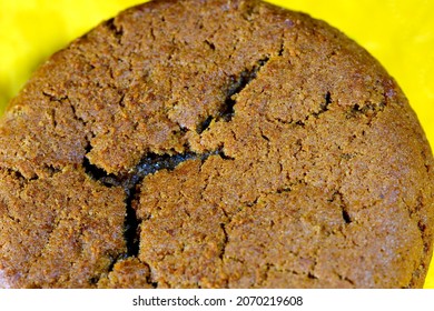 A Macro Shot Of A Molasses Cookie With A Yellow Background