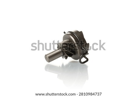 Macro shot of a new motorcycle engine kickstart pinion gear with a friction clip isolated on a white background. High-quality steel helical gear component for scooter, moped, or motorbike transmission repair. High-key studio technical product photography.