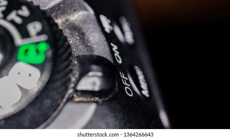 The macro shot of the on and off button of the camera along side other setting buttons