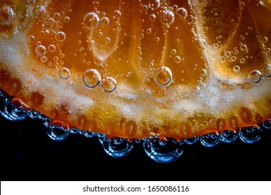 Macro Shot Of An Orange Slice In Seltzer Water