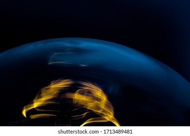Macro shot of shining frame in light bulb isolated on black 