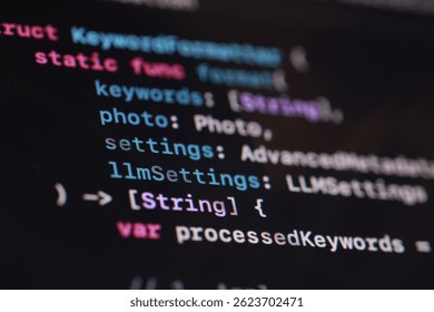 A macro shot showcases vibrant code displayed on a dark computer screen. The image highlights software development, programming, technology, and the intricacies of digital creation with colorful text