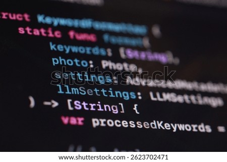 A macro shot showcases vibrant code displayed on a dark computer screen. The image highlights software development, programming, technology, and the intricacies of digital creation with colorful text