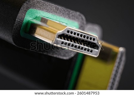 Macro shot showcasing robust HDMI cables designed for seamless data exchange, ensuring crisp multimedia experiences in home theaters, offices, or studios. Photo