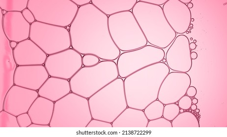 Macro shot of soap different sized transparent soap bubbles creating a bubble grid on pink background | Macro shot of skincare lotion ingredients for its commercial - Shutterstock ID 2138722299