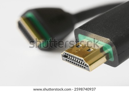 Macro shot of two HDMI cable ends highlighting reliable connectivity for digital devices. Suitable for illustrating electronics, home theater, or computing setups. Photo