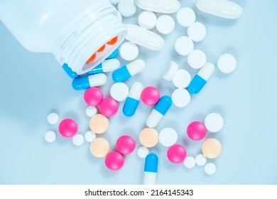Macro shot of various colored pills on a white background, close-up health care and medical concept - Shutterstock ID 2164145343