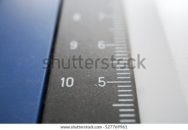 Macro shot of the vertical guide on a\
drawing board. The rule is divided in\
millimeters.