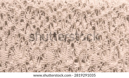 Macro shot of white openwork knitted mesh fabric texture background with intricate yarn pattern and detailed textile weave structure