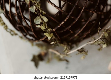 A Macro Shot Of A Wooden Candle Holder Covered With Leaves