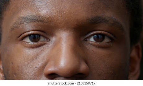 Macro Shot Of Young Adult Blinking In Front Of Camera, Showing Eyes With Colored Iris, Retina And Pupil. Man Looking At Reflection, Healthy Focus And Eyesight. Eyebrows And Eyelashes. Authentic Look.