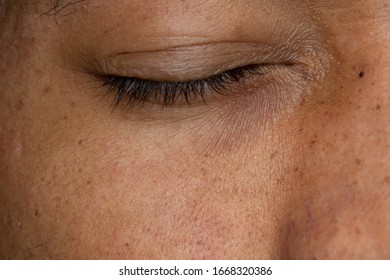 Macro shot of a young African man with closed eye