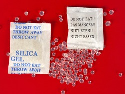 Macro Of Silica Gel Bags On Red Background