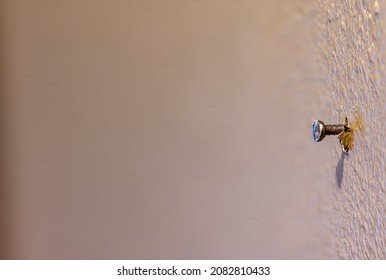 Macro Of A Single Nail Protruding From Painted Drywall In A Residential House