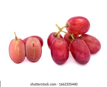 Macro Small Bunch Of Wet Fresh Red Seedless Grapes And Cut Half Pieces Isolated On White Background.