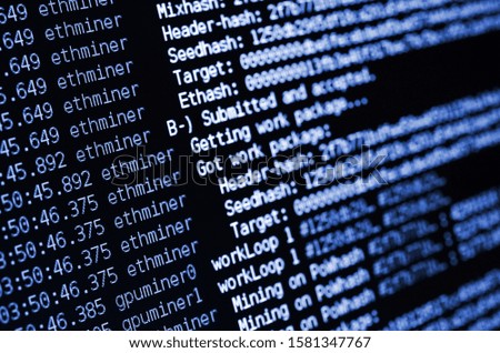 Macro snapshot of the program interface for crypto currency mining on the monitor of an office computer. The flow of information strings and data. phantom classic blue color.