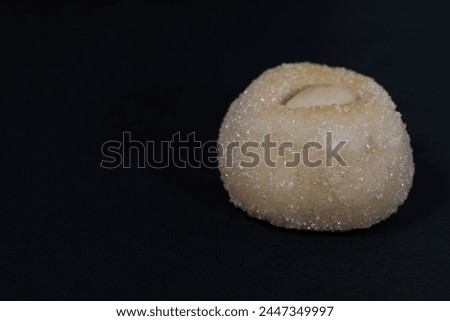 Macro of Sugared Coconut Panellet with Almond on black background