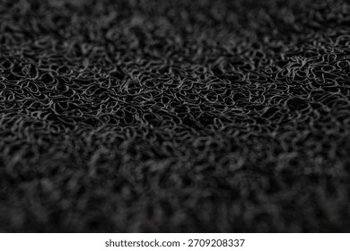 Macro Texture of Black Vinyl Loop Noodle Mat or Spaghetti Mat Background