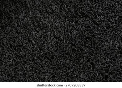 Macro Texture of Black Vinyl Loop Noodle Mat or Spaghetti Mat Background