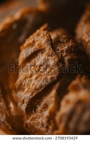 Macro texture of crusty artisan bread with flour, warm moody food background.