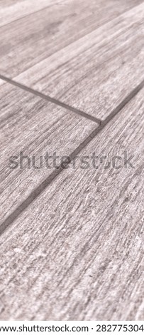 Macro texture of grey wood effect stoneware tiles with bevel edge
